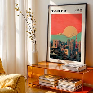 May include: A retro-style poster with a cityscape of Tokyo, Japan. The poster features a red and orange sunset with Mount Fuji in the background. The text "TOKYO" and "JAPAN" is printed in black at the top of the poster.