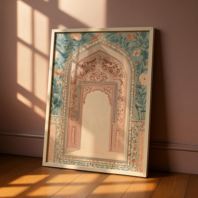 May include: Framed art print featuring an ornate archway design. The artwork showcases a detailed interior with intricate patterns in red and cream, set against a backdrop of teal and floral motifs. The frame is a light beige, and the print is leaning against a wall.