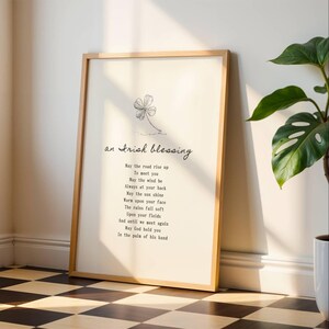 Minimalist Irish Blessing poem print leaning against white wall with houseplant – spiritual and sentimental home decor.