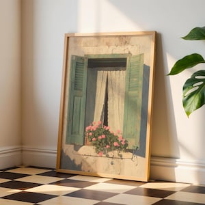 May include: A framed print of a window with green shutters, a white curtain, and pink flowers. The artwork is in a light wood frame and leans against a white wall. The floor is a black and white checkered pattern.