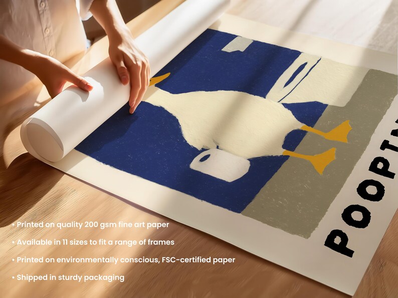 May include: A rolled-up art print featuring a whimsical illustration of a white duck with yellow feet and a white jug against a blue and beige background. The word "POOPT" is printed in black on the right side of the print.