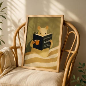 May include: A framed art print depicting a cartoon mouse reading a book titled "A Brief History of Cheese." The mouse holds a mug. The artwork has a warm colour palette and is set against a neutral background.