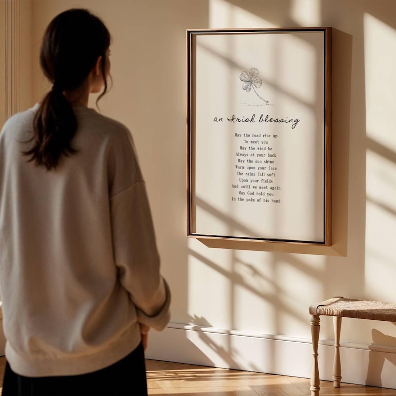 Woman looking at framed Irish Blessing art print in bright interior – thoughtful Irish gift idea for family or friends.