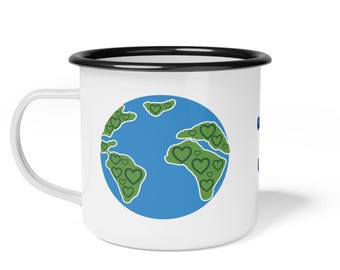May include: White enamel mug with a black rim. The mug features a blue and green illustration of the Earth with green hearts on the continents.