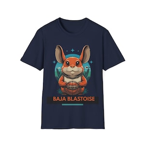 May include: Navy blue t-shirt with a cartoon orange creature holding a basketball. The design includes a blue and green background and the text "BAJA BLASTOISE".