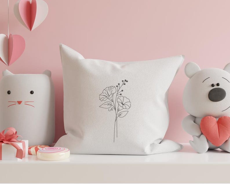 May include: White pillow with a simple line drawing of a flower bouquet on it.