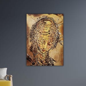 May include: An abstract artwork showing a face with a complex, layered structure. The colour palette is dominated by warm tones of brown and gold, with intricate details suggesting a surreal or dreamlike quality. The artwork is mounted on a wall.