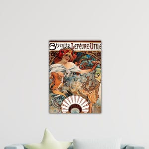 May include: A framed art print featuring a vintage advertisement for "Biscuits Lefèvre-Utile." The artwork depicts a woman with red hair and a floral headdress, holding a plate. The print has a decorative border with ornate details.