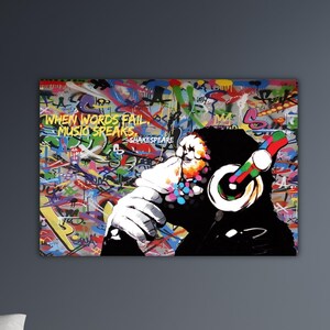 May include: A vibrant graffiti art print featuring a chimpanzee wearing headphones. The artwork includes colorful spray-painted backgrounds and the quote "WHEN WORDS FAIL MUSIC SPEAKS" by Shakespeare.