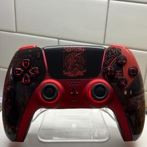 May include: A custom red and black video game controller with the text "SILENT HILL" and a graphic on the center panel. The controller has red accent lighting around the buttons and joysticks.