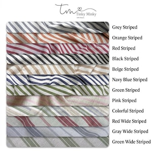 May include: A collection of twelve fabric swatches featuring various striped patterns in colors including grey, orange, red, black, beige, navy blue, green, and pink. The text Tinky Minky Gift Store appears at the top with labels for each stripe.