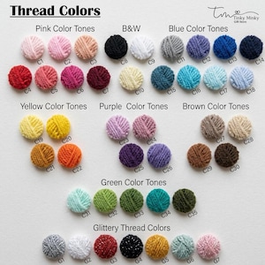 May include: A color chart titled Thread Colors featuring rows of small, circular yarn samples organized by tone. Categories include Pink, B&W, Blue, Yellow, Purple, Brown, Green, and Glittery Thread Colors, each labeled with alphanumeric codes.