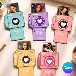 May include: Five rectangular camera-shaped cards in teal, purple, pink, yellow, and light pink. Each features a pull-out photo, a heart-shaped lens, and text including "SEE THE MAGIC," "BEST MOM EVER," "WHO COULD IT BE?," "BEST GIRL EVER," and "MY SWEET LOVE."