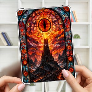 May include: A clear tablet case featuring a stained glass style design of a dark tower under a fiery eye. The artwork displays vibrant orange, red, and blue hues with intricate patterns. The text Wildflower&Pages is printed in the centre.
