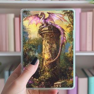 May include: A clear phone case with a colorful image of a pink dragon perched on a stone pillar in a forest setting.