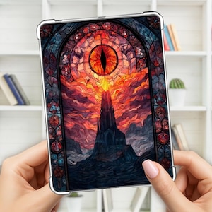May include: A tablet case featuring a stained-glass design with a fiery eye at the center, surrounded by a castle silhouette and a vibrant red and orange sky. The case has a clear, protective frame.