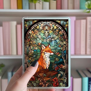 May include: A stained glass style image of a fox sitting in a garden with flowers and leaves. The fox is orange and white with a black nose and eyes. The background is a mix of green, blue, and red.