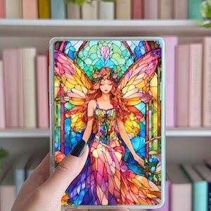 Könnte beinhalten: Transparente Handyhülle mit einem farbenfrohen Buntglasdesign einer Fee mit großen Flügeln und einem Blumenkranz. Die Fee trägt ein mehrfarbiges Kleid. Im Hintergrund ein Bücherregal mit verschiedenen Büchern.