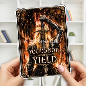May include: A rectangular protective tablet case featuring a graphic illustration of a blonde warrior in dark armour holding a sword upright against a fiery orange and black background. The text "YOU DO NOT YIELD" is printed in gold lettering.