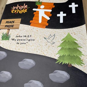 May include: A graphic with a road design featuring text that reads "inhale exhale", "PEACE PAUSE", and Bible verses. The image includes a bridge, crosses, a dove, and trees. The road is lined with gray stones.