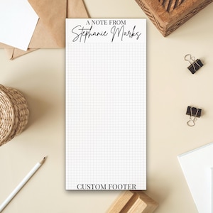 May include: A white notepad with a grid pattern. The top of the notepad says "A Note From Stephanie Marks". The bottom of the notepad says "CUSTOM FOOTER".