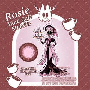 Könnte beinhalten: Ein Rosie Maid Cafe Aufsteller mit einer Figur in einem schwarz-rosa Dienstmädchen-Outfit, die ein Etagere mit Cupcakes hält. Das Design umfasst einen runden Spitzen-Sockel, weiße Kaffeetassen und Text mit der Aufschrift Rosie Maid Cafe Standee.