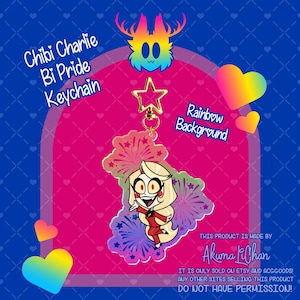 May include: A clear acrylic keyring featuring a chibi-style character with blonde hair and a red suit, surrounded by a colourful firework pattern. The keyring is attached to a gold-coloured star-shaped clasp. Text includes Chibi Charlie Bi Pride Keychain.