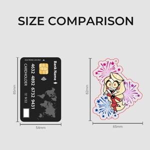 May include: A size comparison graphic featuring a black bank card measuring 85mm by 54mm next to a character keychain measuring 82mm by 65mm. The keychain depicts a blonde character in a red suit surrounded by pink and blue firework illustrations.