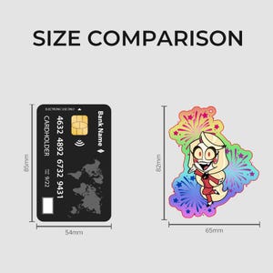 May include: A black credit card measuring 85mm by 54mm next to a colourful character sticker measuring 82mm by 65mm. The card features a world map graphic, chip, and text. The sticker depicts a blonde cartoon character in a red suit against a rainbow firework background. The text SIZE COMPARISON is at the top.