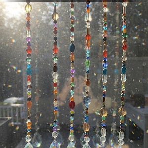 May include: A white ceramic mug with a black handle and the text "But First, Coffee" in a black, bold font. The mug is sitting on a wooden surface. The mug is approximately 4 inches tall.