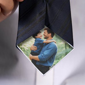 Könnte beinhalten: Marineblaue Krawatte mit schwarzem Streifenmuster. Die Krawatte zeigt ein personalisiertes Foto eines Mannes und eines Kindes, das sich umarmt. Das Foto ist auf der Vorderseite zu sehen, was ein einzigartiges Accessoire ergibt.