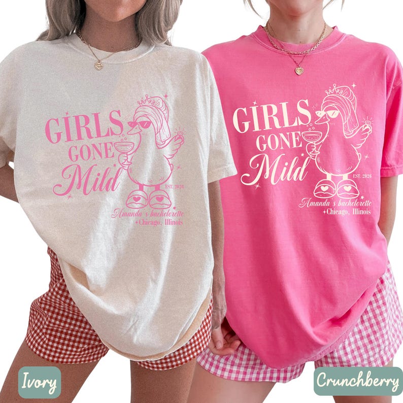 May include: Two t-shirts, one cream and one pink, with the text "GIRLS GONE Mild" and a cartoon duck wearing sunglasses and holding a drink. The text "Amanda's bachelorette + Chicago, Illinois" is also printed on the shirts.