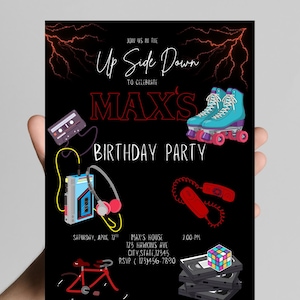 May include: Black invitation with the text "Up Side Down" and "Max's Birthday Party." Features illustrations of roller skates, a cassette player, a telephone, a Rubik's Cube, a bicycle, and a cassette tape. Includes date, time, and address.