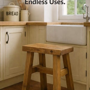 May include: A rectangular wooden stool with a natural brown finish and four sturdy legs connected by horizontal support bars. The text One Stool. Endless Uses. is displayed above the stool in a dark brown font against a kitchen background.