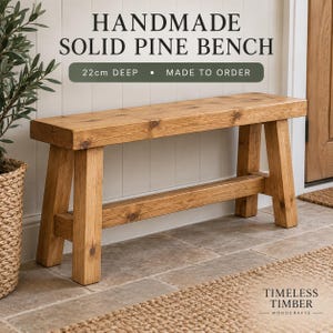May include: A rectangular bench made of solid pine wood with a natural light brown finish and visible wood grain. The bench features four sturdy legs and a horizontal support beam. Text on the image reads: HANDMADE SOLID PINE BENCH 22cm DEEP.