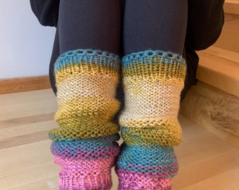 May include: A pair of colorful knitted leg warmers with a pink, blue, green, and yellow striped pattern. The leg warmers are made with a soft, textured yarn and have a crocheted top edge.