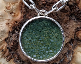 Hemp for Victory hand engraved pendant and chain dinosaur bone encapsulated with a synthetic sapphire cap