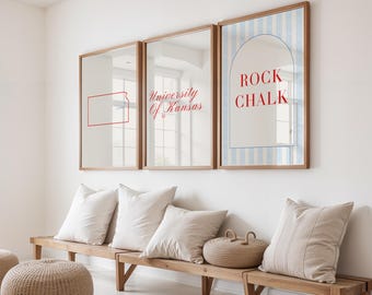 May include: Three framed mirrors with wooden frames hang above a wooden bench with pillows. The mirrors display the text "University Of Kansas", a red outline of Kansas, and the words "ROCK CHALK" on a blue and white striped background.