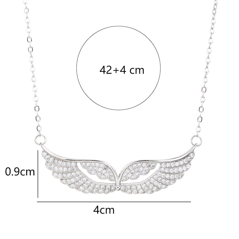 May include: A silver-toned necklace featuring a wing-shaped pendant adorned with small, sparkling stones. The pendant is 4 cm wide and 0.9 cm high. The chain is 42+4 cm long. The necklace is designed to be worn around the neck.