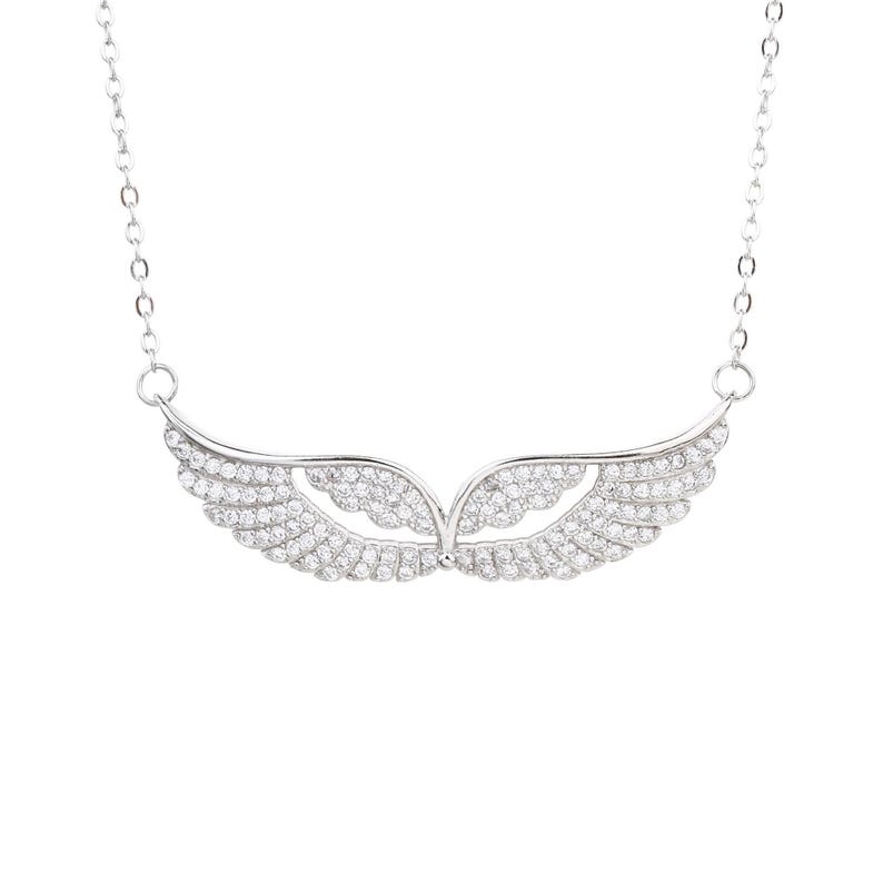 May include: A silver-toned necklace featuring a pendant shaped like stylized wings. The wings are encrusted with small, sparkling crystals, creating a shimmering effect. The necklace hangs on a delicate chain.