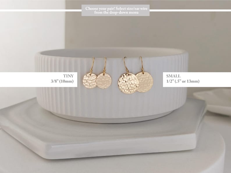 May include: Gold-colored disc earrings in two sizes: tiny (3/8 inch) and small (1/2 inch). The earrings are displayed on a white, textured bowl. The text on the image reads: "Choose your pair! Select size/ear wire from the drop-down menu."