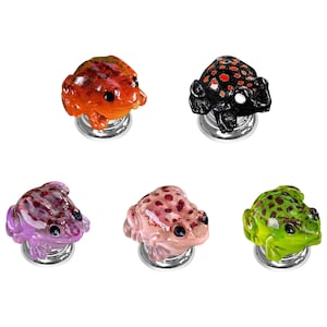 May include: Five decorative cabinet knobs shaped like frogs, each featuring a unique color scheme including orange, black with red spots, purple, light pink, and green with dark spots, all mounted on circular silver-toned metal bases.