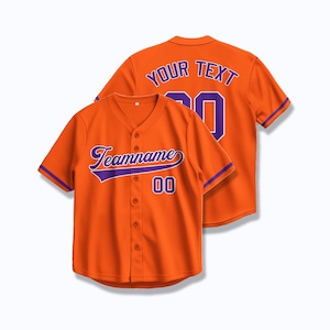 May include: Orange baseball jersey with purple trim and text. The front of the jersey has the text "Teamname" and the number "00". The back of the jersey has the text "YOUR TEXT" and the number "00".