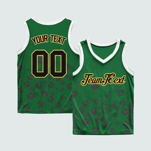 May include: Green basketball jersey with white trim and a leopard print pattern. The front features the text "Team Text" in gold script. The back displays the text "YOUR TEXT" above the number "00" in gold and black.