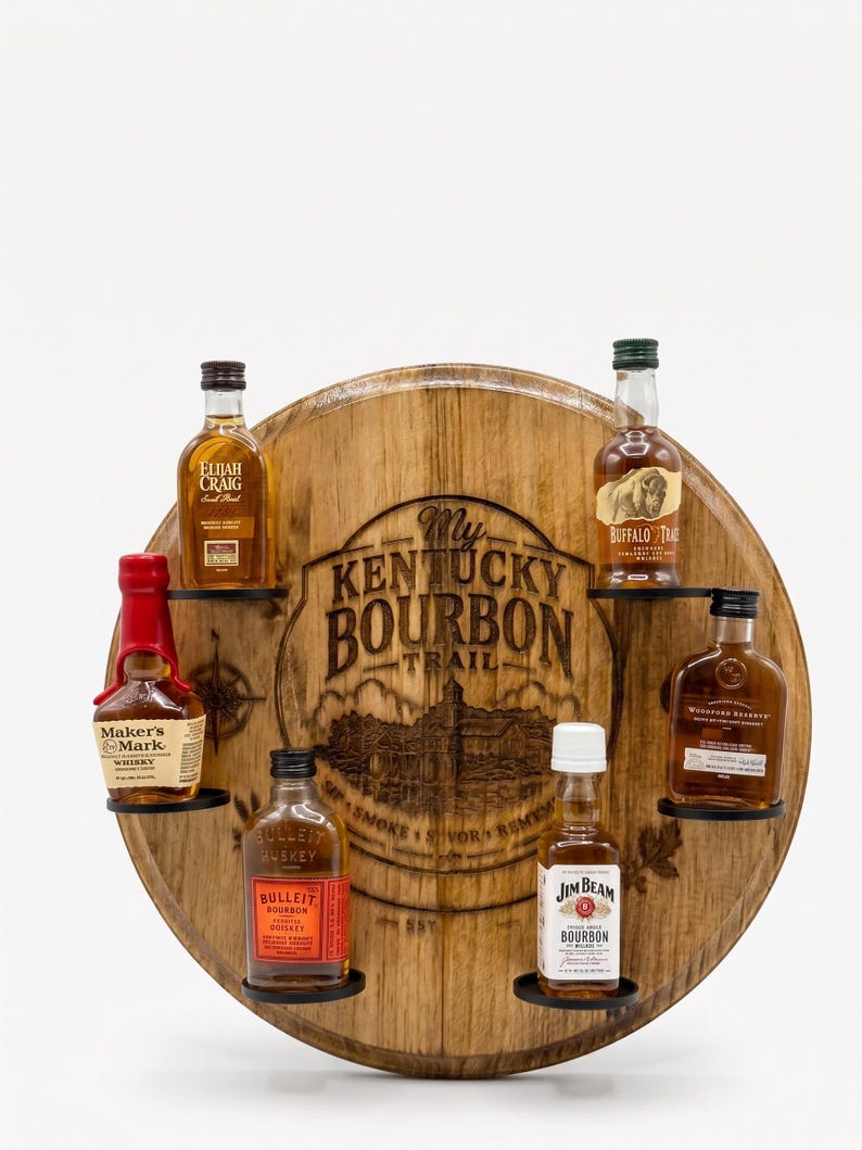 May include: A circular wooden barrel head display rack featuring the engraved text My Kentucky Bourbon Trail. The rack holds six miniature bottles of bourbon, including brands like Maker's Mark, Elijah Craig, Buffalo Trace, and Jim Beam.