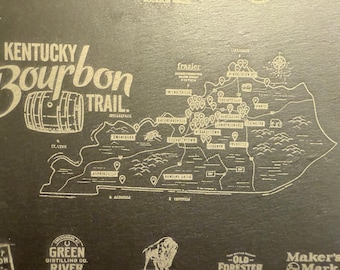 Pode incluir: Um mapa do Kentucky Bourbon Trail, apresentando um contorno detalhado do estado com destilarias marcadas. O design inclui o texto "Kentucky Bourbon Trail" e uma ilustração de barril, tudo em cor clara sobre um fundo escuro.