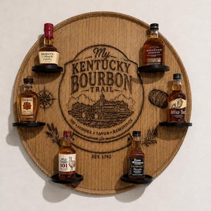 May include: A circular wooden display board featuring the engraved text My Kentucky Bourbon Trail, Est. 1792, Sip, Smoke, Savor, Reminisce, and a landscape illustration. Six small black shelves hold miniature bottles of bourbon whisky.