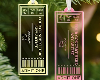 May include: Two concert ticket ornaments. One is yellow, the other is pink. Both have the text "YOUR CONCERT HERE ANY ARTIST" and "ADMIT ONE". Each ticket has a white ribbon for hanging.