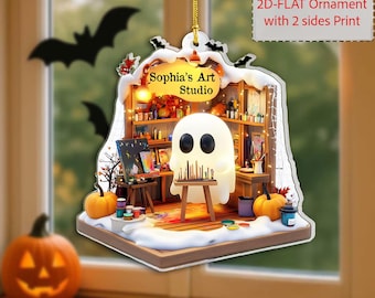 May include: A Halloween-themed ornament featuring a glowing ghost in an art studio setting. The ornament includes a sign that reads "Sophia's Art Studio", pumpkins, and bats. The ornament is designed with a 2D-flat print.