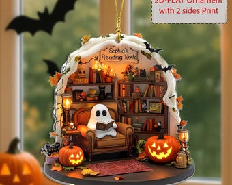 May include: A Halloween-themed ornament featuring a miniature reading nook with a ghost reading a book in a brown armchair. The ornament includes a bookshelf, pumpkins, bats, and the text "Sophia's Reading Nook". The ornament is a 2D-flat design.